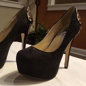 Black platform shoes with gold butterfly detail